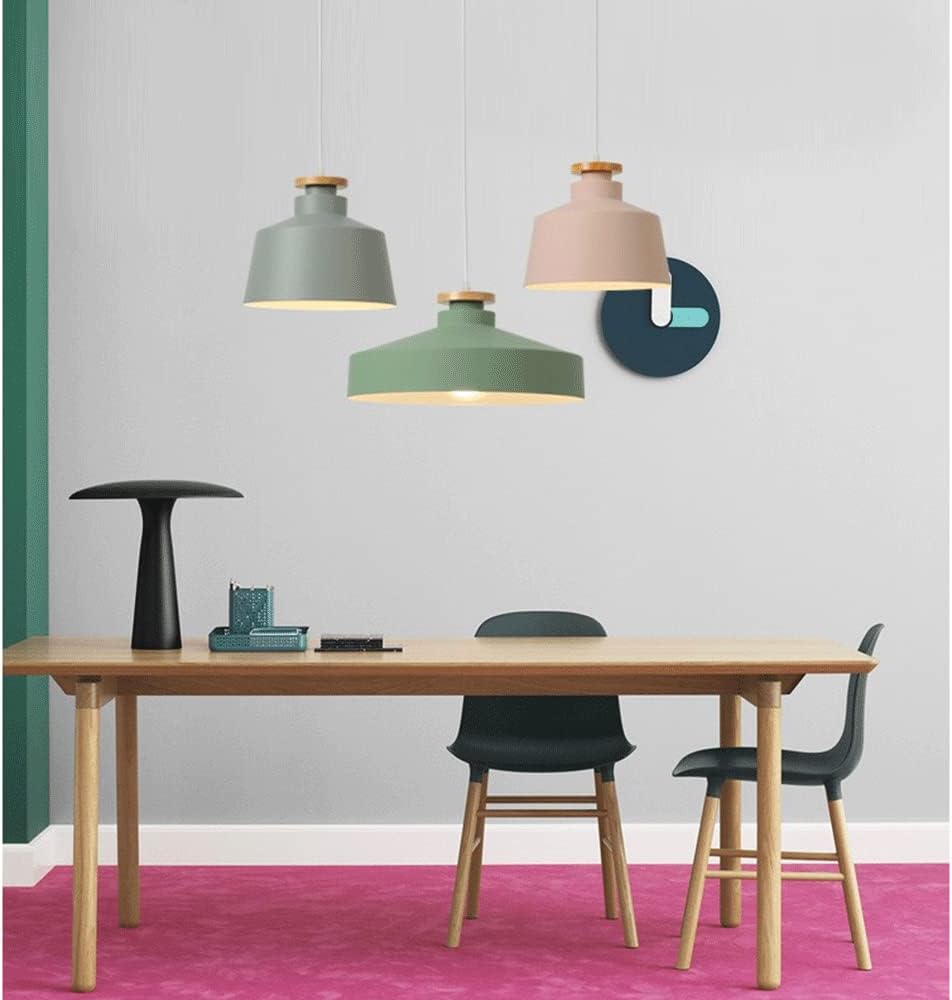 Modern dining area with a wooden table, black chairs, and colorful pendant lights.