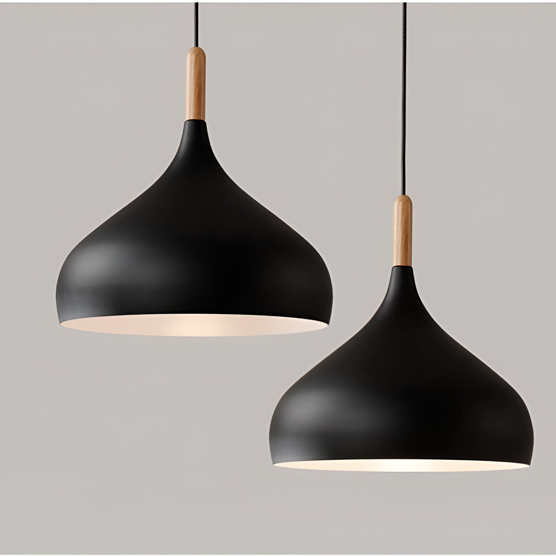 Two black pendant lights with wooden accents on a gray background