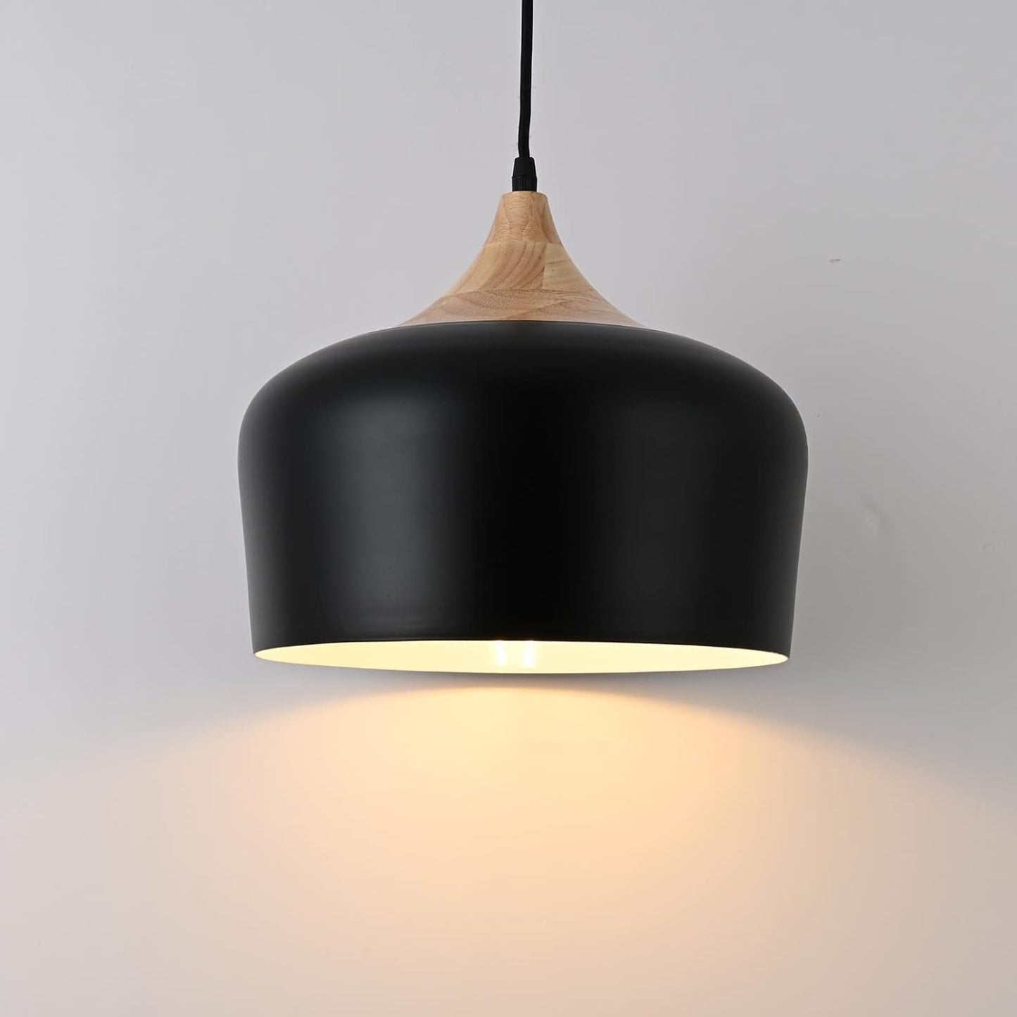 Black pendant light with wooden top on a gray background